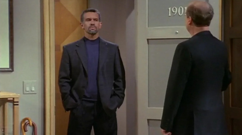 Kelsey Grammer as Frasier Crane looks at Brian Stokes Mitchell as Cam Winston standing in his doorway on Frasier.