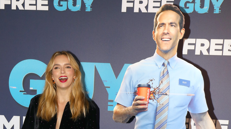 Jodie Comer posing with Ryan Reynolds cutout