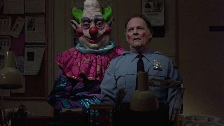 One of the Killer Klowns from Outer Space holds a cop