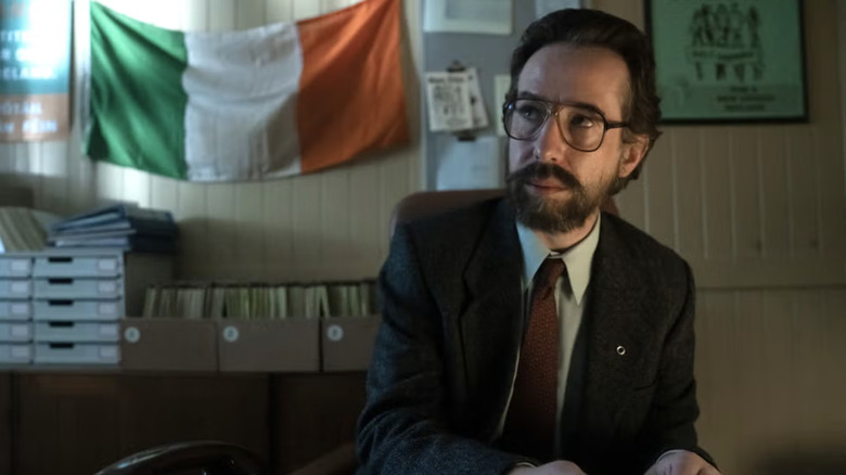 Gerry Adams in an office with the Irish flag mounted on the wall in Say Nohing