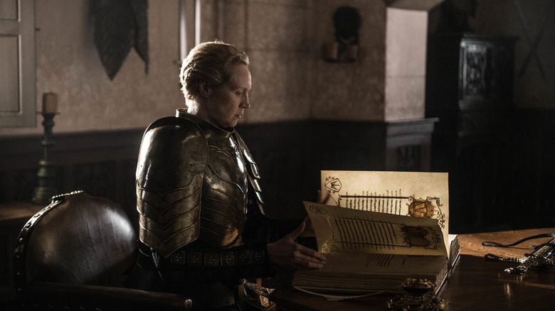 Brienne writing in a large book in Game of Thrones