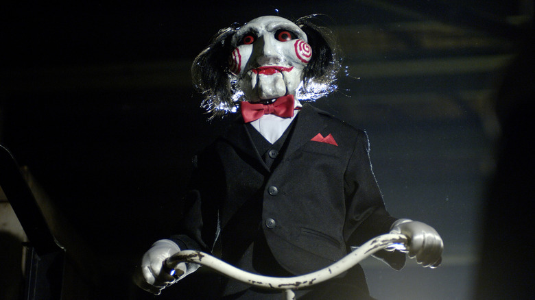 The Billy puppet on his bike in Saw (2004)