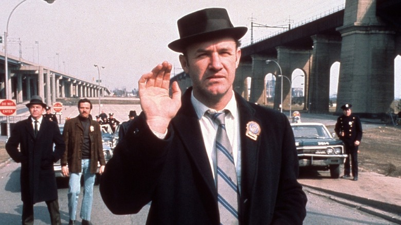 Gene Hackman's Popeye Doyle raising his hand in The French Connection