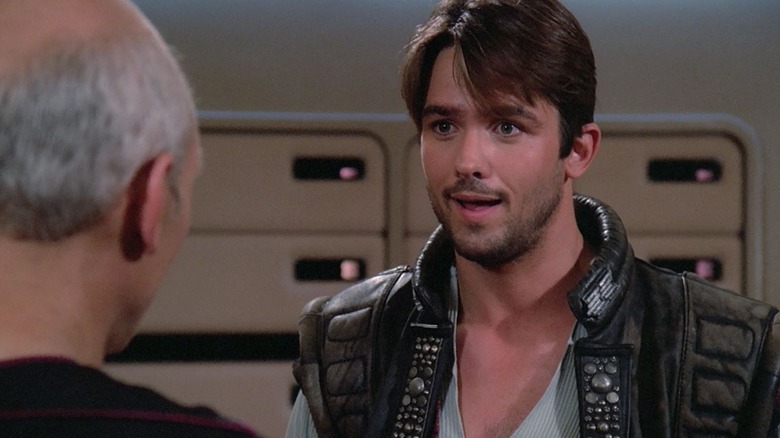 The Outrageous Okona (Billy Campbell) talking to Captain Picard (Patrick Stewart) on the bridge of the Enterprise in Star Trek: The Next Generation