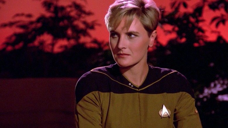 Tasha Yar on an exotic planet with red skies in Star Trek: The Next Generation