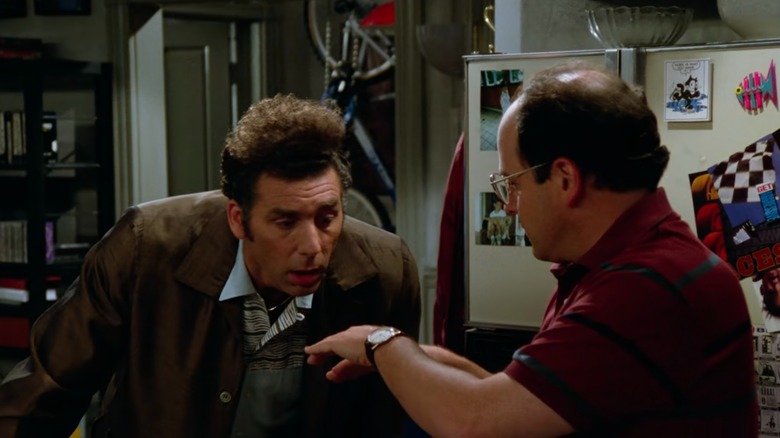 Michael Richards' Kramer inspects the model hands of Jason Alexander's George in Seinfeld