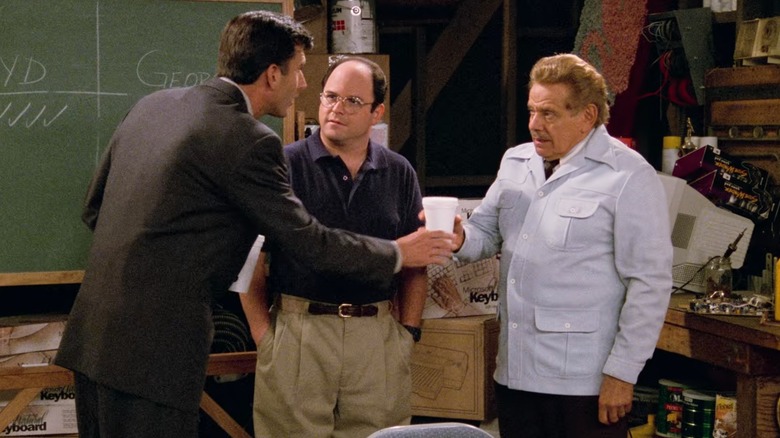 Matt McCoy's Lloyd Braun shakes the hand of Jerry Stiller's Frank while Jason Alexander's George looks unimpressed, in Seinfeld