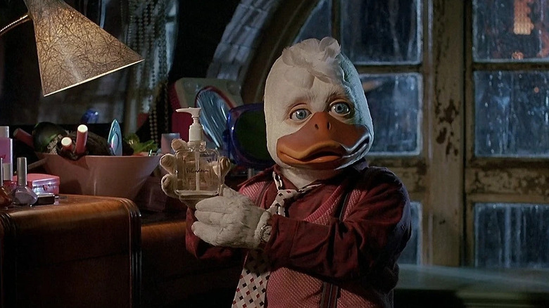 Howard holds a dispenser bottle of liquid in Howard the Duck