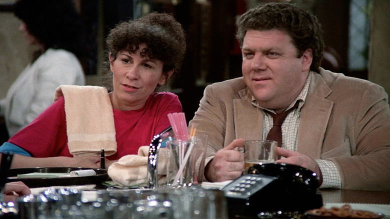 Rhea Perlman as Carla and George Wendt as Norm sitting at the bar in Cheers