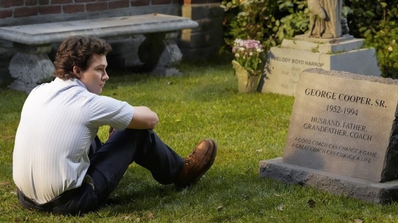 Georgi sits next to his father's grave on Georgi and Mendy's first marriage