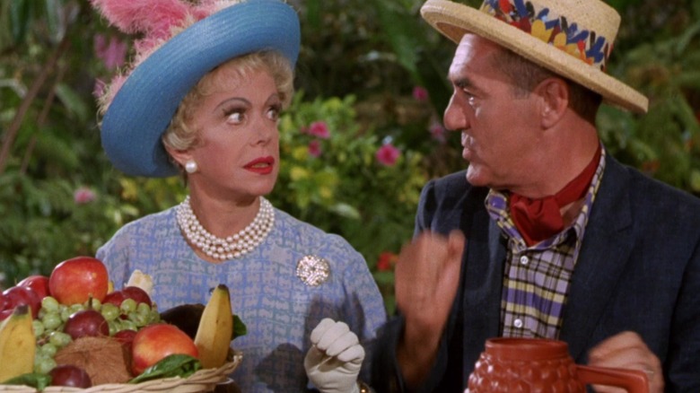 Mrs. Howell in a feathered hat talking to Mr. Howell  on Gilligan's Island