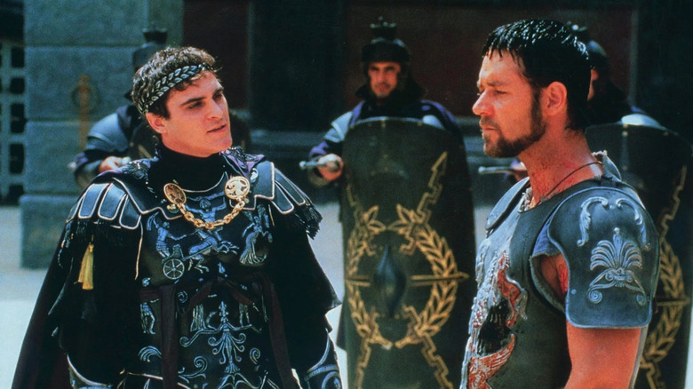 Maximus and Commodus stand in armor