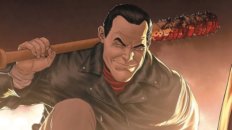 Negan with has bat Lucille on the cover of The Walking Dead Deluxe #100