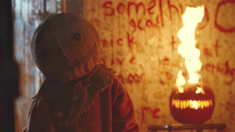 Sam and a fiery jack-o-lantern in Trick 'R Treat