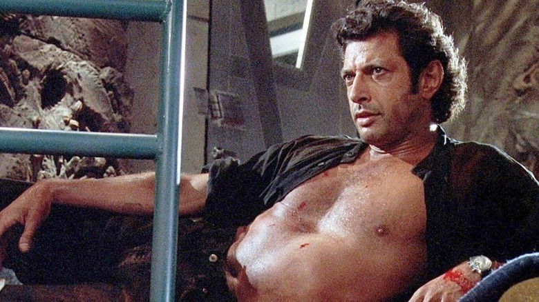 Jeff Goldblum laying with shirt unbuttoned in Jurassic Park