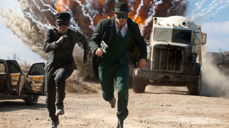 Kato and Britt Reid fleeing an explosion in The Green Hornet (2011)