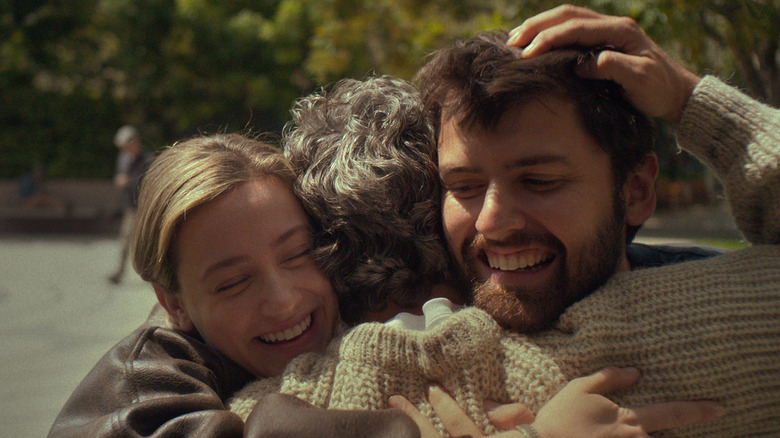 Lili Reinhart and Cooper Raiff as Hal & Harper, smiling and hugging their father, played by Mark Ruffalo