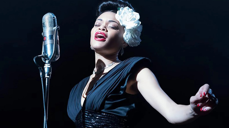 Billie Holiday, as played by Andra Day, singing at a mic in The People vs. Billie Holiday