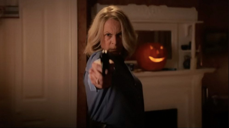 Laurie aims a gun at her nemesis Michael in Halloween Ends