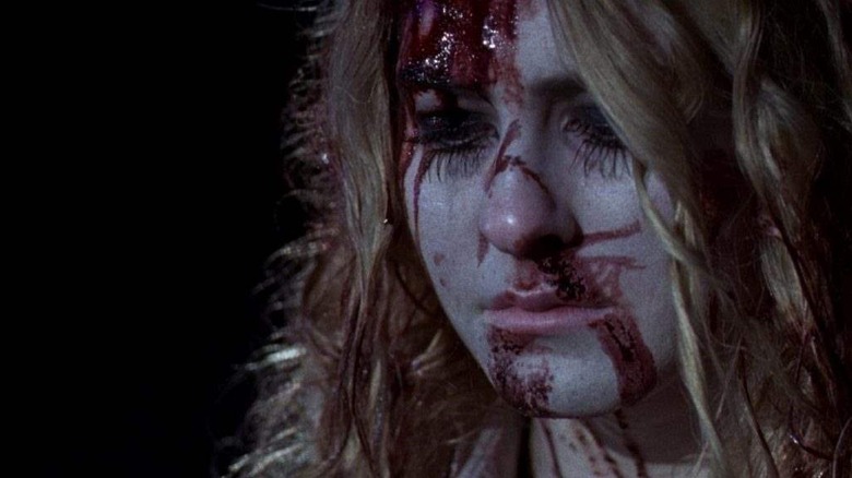 A bloody Laurie Strode played by Scout Taylor-Compton contemplates her sanity in Halloween ii