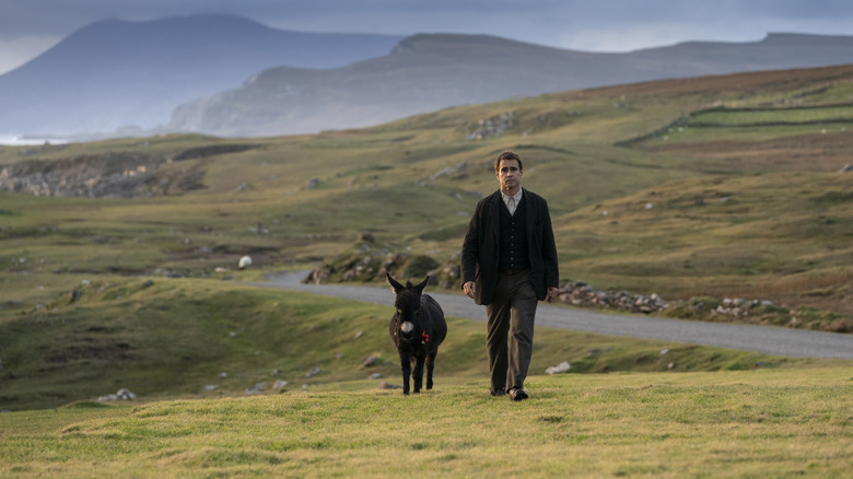 Colin Farrell walking with donkey