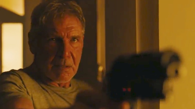 Rick Deckard holding a blaster