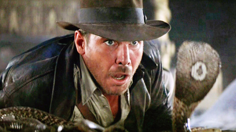 Indiana Jones looking scared at a snake