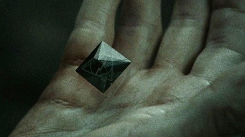 Resurrection Stone in hand Deathly Hallows