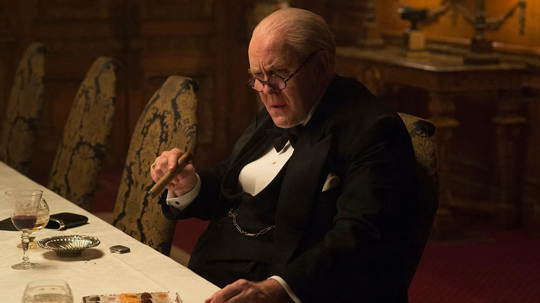 Winston Churchill in a tuxedo smoking a cigar on The Crown