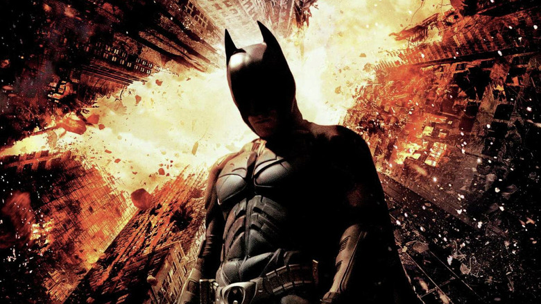 The Dark Knight Rises poster showing Batman standing in crumbling Gotham skyline, forming the shape of a bat