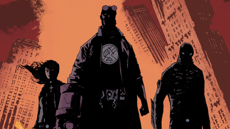 Liz Sherman, Hellboy, and Abe Sapien standing together in a burning city in BPRD The Devil You Know