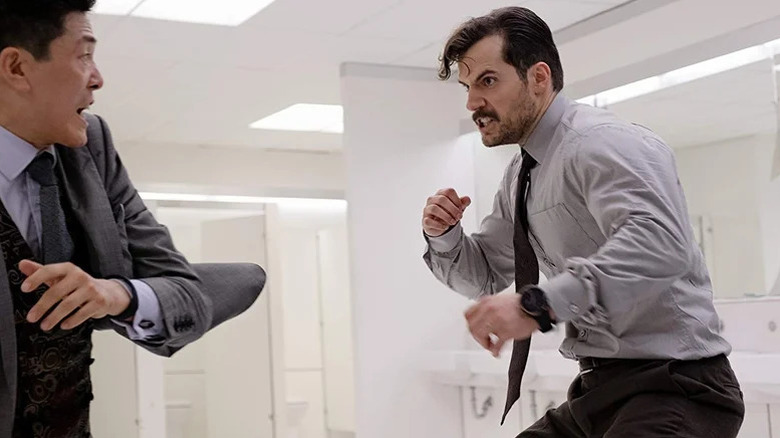 August Walker about to beat up a man in a suit in a bathroom in Mission: Impossible – Fallout