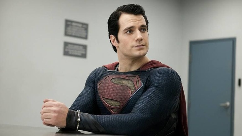 Man of Steel Superman sitting at a table handcuffed