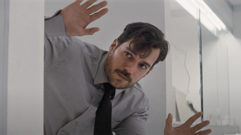 August Walker puts his hands up as he emerges from a bathroom stall in Mission: Impossible – Fallout