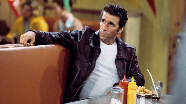 The Fonz in a restaurant booth, looking cool.