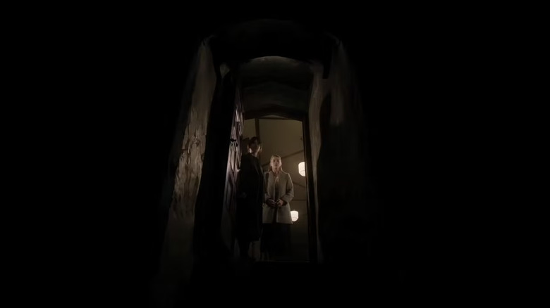 Sister Barnes and Sister Paxton standing at the top of dark stairs looking into the black abyss in heretic