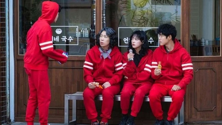 Family in jumpsuits eating snacks