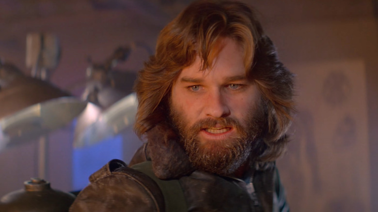 MacReady stares into a fire in The Thing
