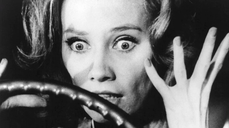 Candace Hilligoss shocked in front of steering wheel in Carnival of Horrors