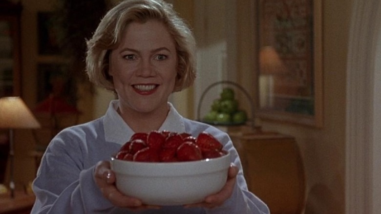 Kathleen Turner holding bowl of strawberries