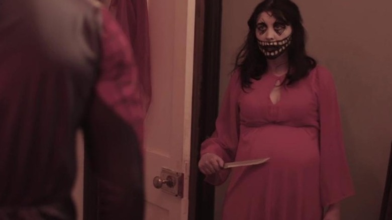 Alice Lowe holding knife to pregnant belly 