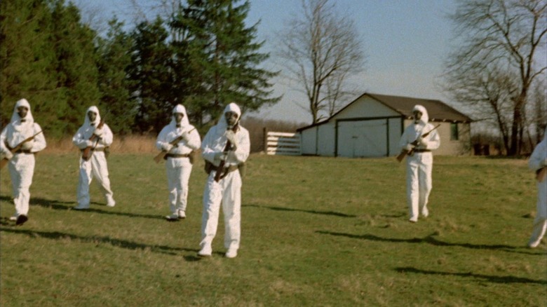 Scientists in hazard suits in field 