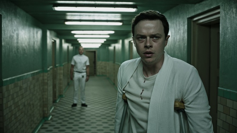 Lockhart on crutches in hall in A Cure for Wellness