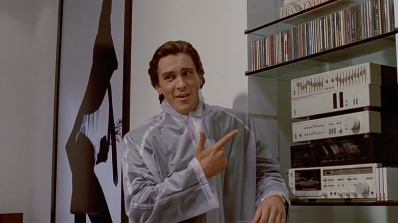 Christian Bale as Patrick Bateman pointing to a CD player in "American Psycho."