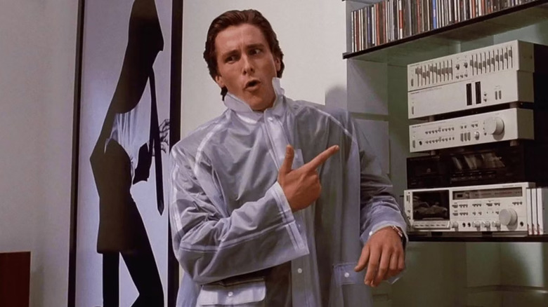 Christian Bale as Patrick Bateman pointing at a stereo in American Psycho.