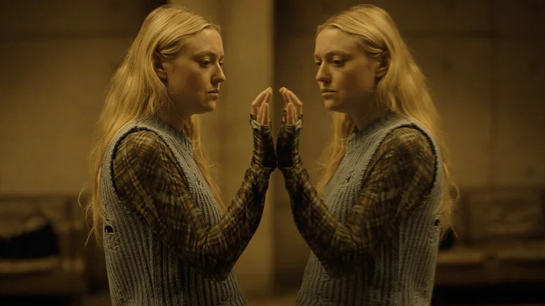 Dakota Fanning standing in front of mirror in The Watchers