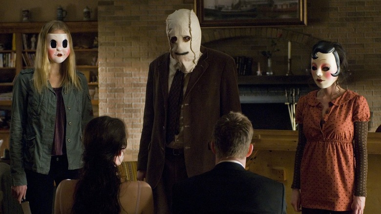 The Strangers masked killers in living room