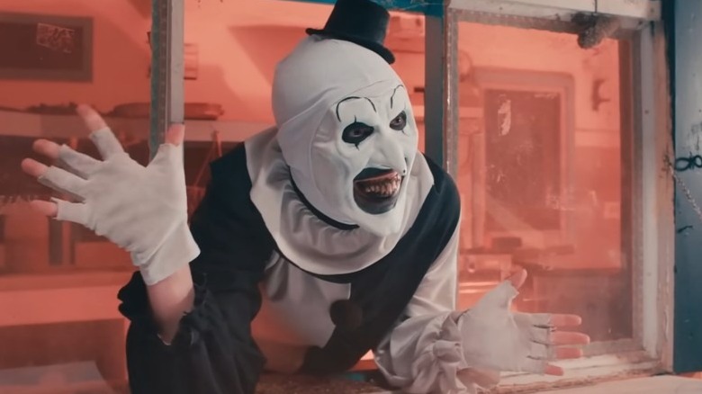 Terrifier 2's Art the Clown waving and smiling