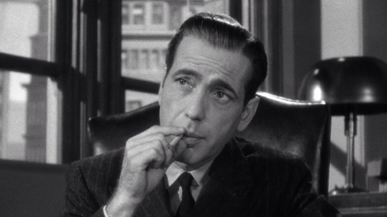 Sam Spade lighting up in The Maltese Falcon.