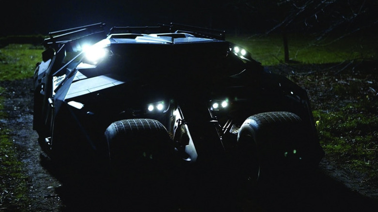 The Tumbler from Batman Begins in the dark with small lights illuminated